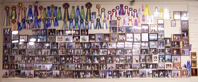 Wall covered with award ribbons and photos