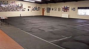 Large empty room covered in black mats